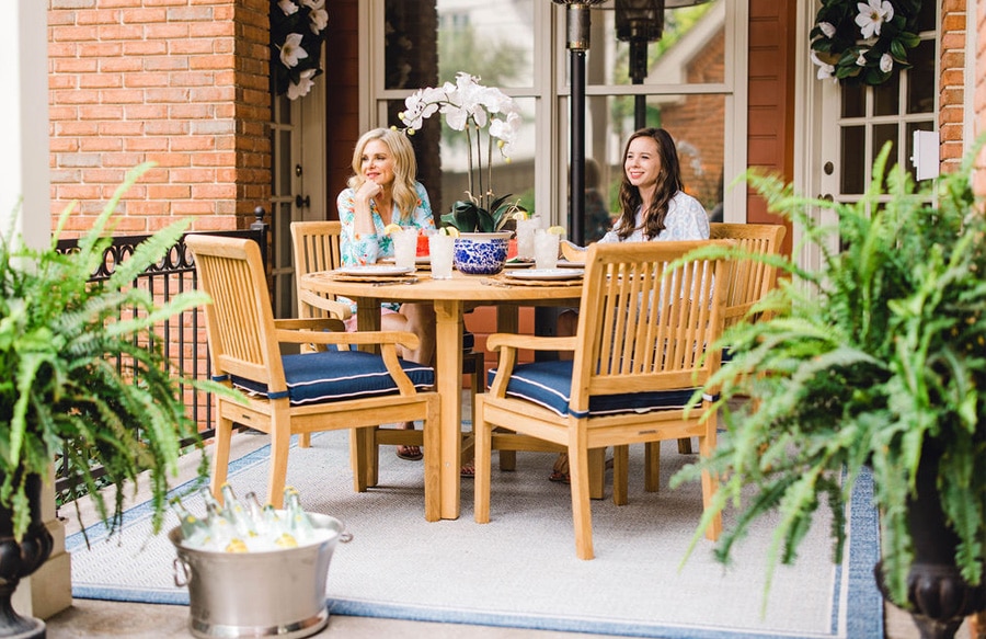 two women sitting on patio